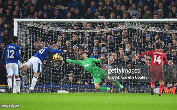 Wayne Rooney of Everton scores their third goal from the penalty psot past goalkeeper Lukasz Fabianski of Swansea City during the Premier League...