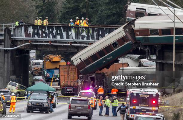 Emegency crews work at the scene of a Amtrak train derailment on December 18, 2017 in DuPont, Washington. At least six people were killed when a...