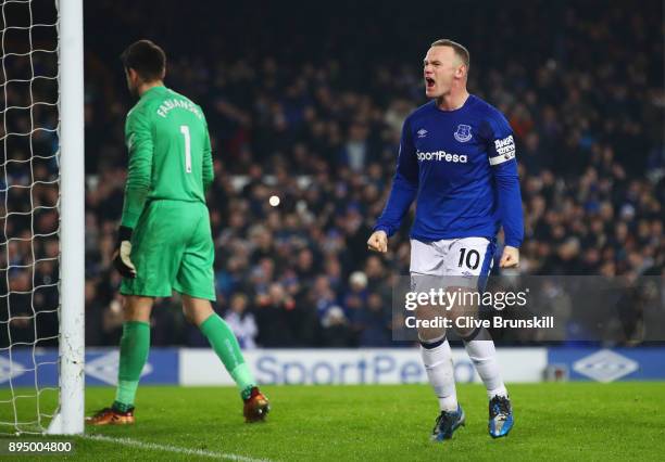 Wayne Rooney of Everton celebrates as he scores their third goal from the penalty spot as Lukasz Fabianski of Swansea City looks dejected during the...