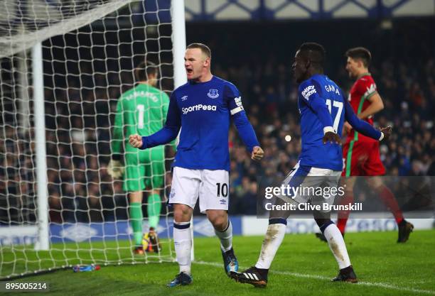 Wayne Rooney of Everton celebrates as he scores their third goal from the penalty spot with Idrissa Gueye during the Premier League match between...