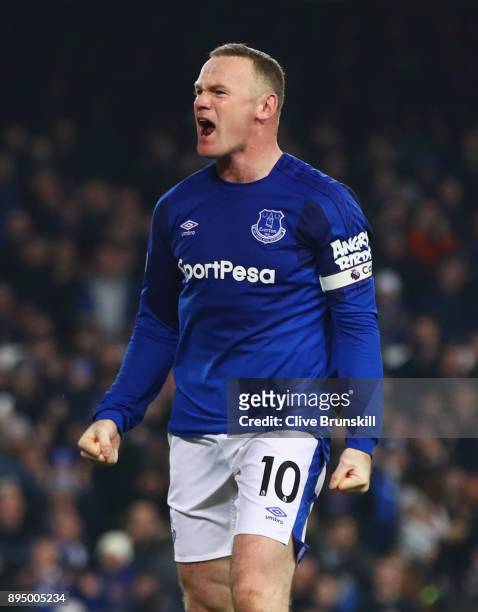 Wayne Rooney of Everton celebrates as he scores their third goal from the penalty spot during the Premier League match between Everton and Swansea...