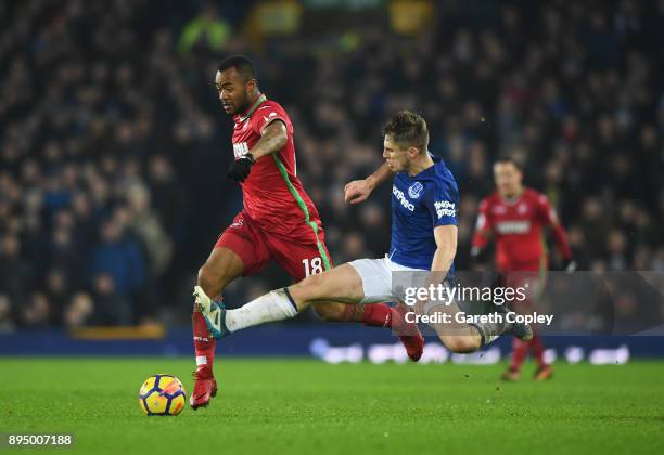 Jordan Ayew of Swansea City is challenged by Jonjoe Kenny of Everton during the Premier League match between Everton and Swansea City at Goodison...