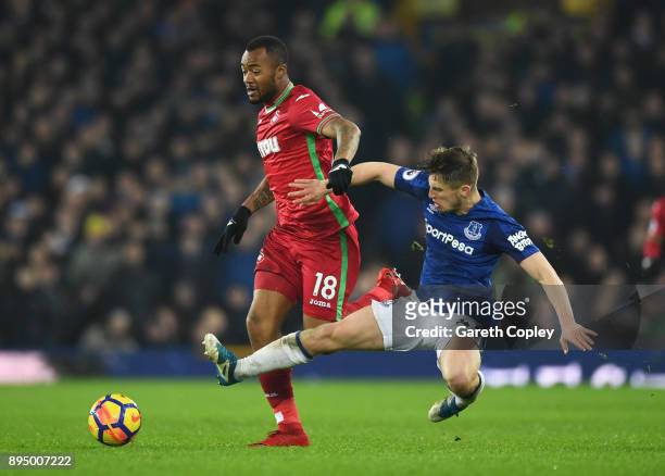 Jordan Ayew of Swansea City is challenged by Jonjoe Kenny of Everton during the Premier League match between Everton and Swansea City at Goodison...