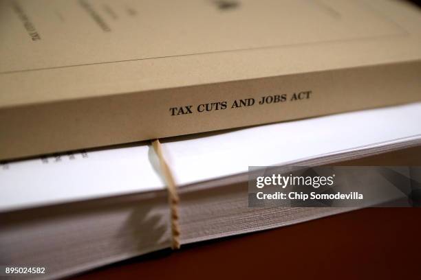 Copy of the Tax Cuts and Jobs Act Conference Report sits on the dais of the House Rules Committee at the U.S. Capitol December 18, 2017 in...