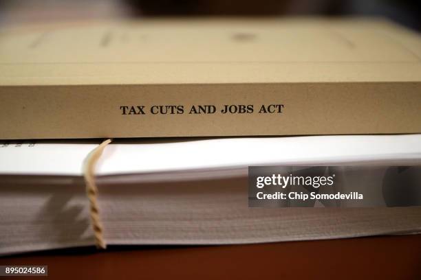 Copy of the Tax Cuts and Jobs Act Conference Report sits on the dais of the House Rules Committee at the U.S. Capitol December 18, 2017 in...