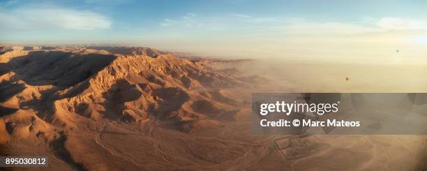 low aerial view from hot-air balloon of the western desert at qurna (luxor) at sunrise - marc mateos stock pictures, royalty-free photos & images