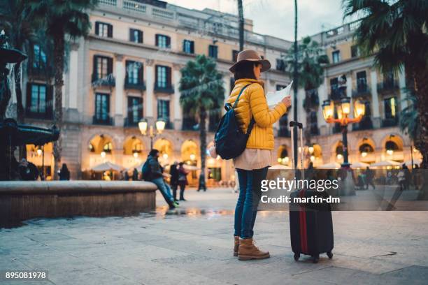 solo traveler with map at placa reial,barcelona - girls of spain stock pictures, royalty-free photos & images