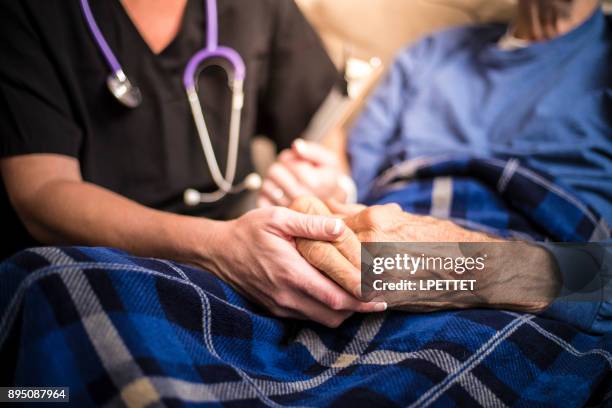 hospice verpleegkundige een bezoek aan een oudere mannelijke patiënt - hospitium stockfoto's en -beelden