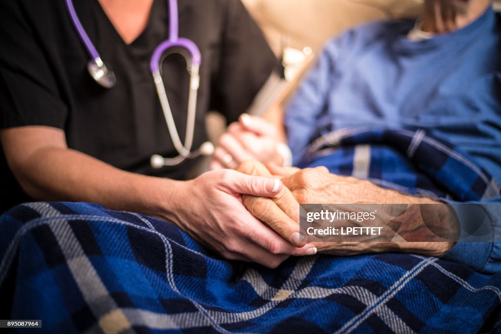 Hospice Nurse visiting an elderly male patient