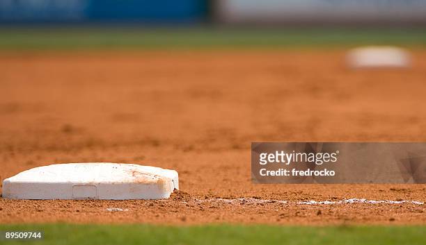 ground level view of a base on the baseball field - baseball base stock pictures, royalty-free photos & images