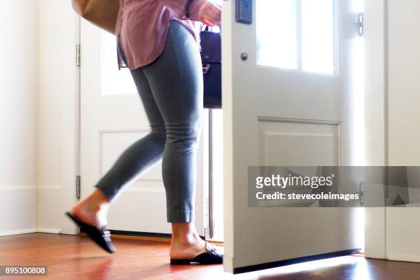 woman carrying walking out from door. - leaving stock pictures, royalty-free photos & images