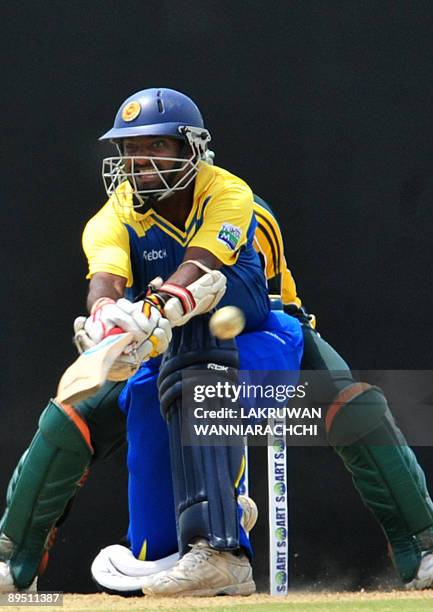 Sri Lankan cricketer Muttiah Muralitharan plays a shot during the first One Day International match between Sri Lanka and Pakistan at The Rangiri...