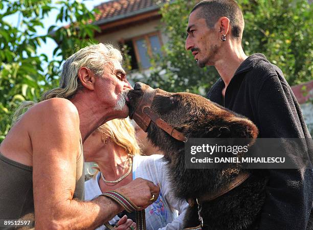 Baloo, a one-year and four-month-old bear, is comforted by his owner, Molnar Mircea, before being placed in a cage on July 30, 2009 and taken away...