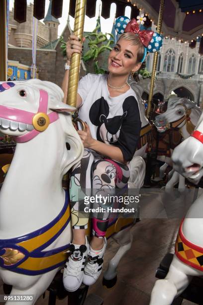 In this handout photo provided by Disney Parks, singer Katy Perry takes a ride on The Prince Charming Regal Carousel at the Magic Kingdom Park on...