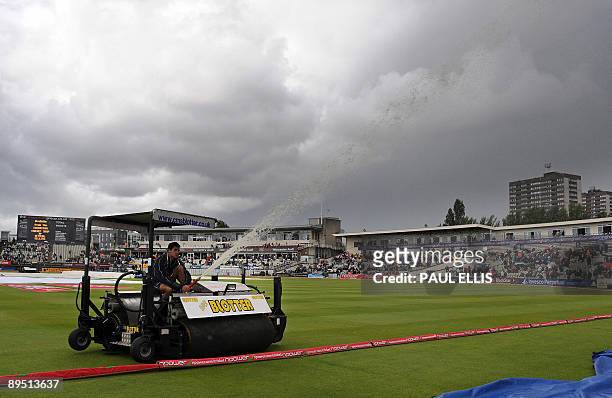 Groundsman uses a Blotter to move water from the outfield as rain delays the start of play on the first day of the third Ashes cricket test between...
