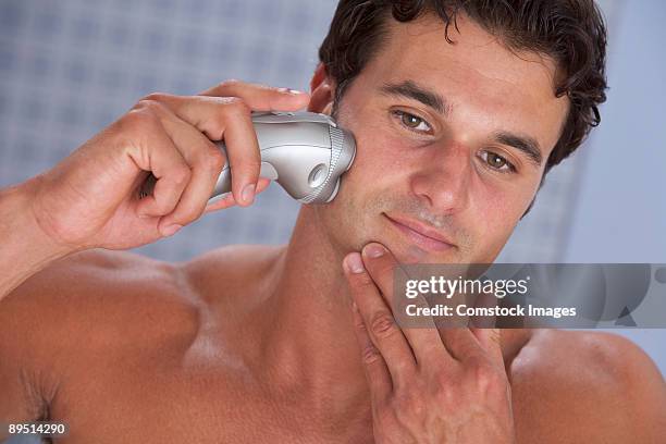 man using electric shaver - electric razor stock pictures, royalty-free photos & images