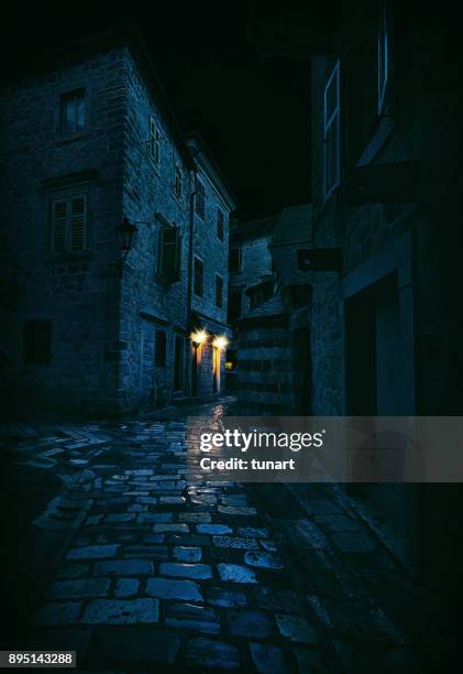 light in a dark alley, kotor, montenegro - cobblestone pathway stock pictures, royalty-free photos & images