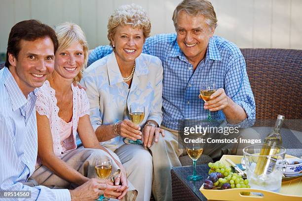 older and younger couple outside having drinks - older woman younger man stock-fotos und bilder