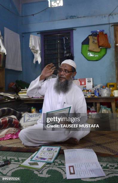 In this photograph taken on October 20 Myanmar Rohingya Islamic scholar Muhammed Hanif speaks during an interivew with AFP at a madrassa in the...