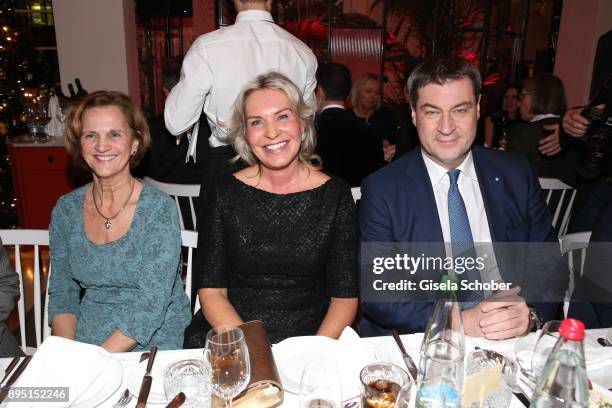 Karin Seehofer, Saskia Greipl and Markus Soeder during the annual Christmas Roast Kid Dinner on December 18, 2017 in Munich, Germany.