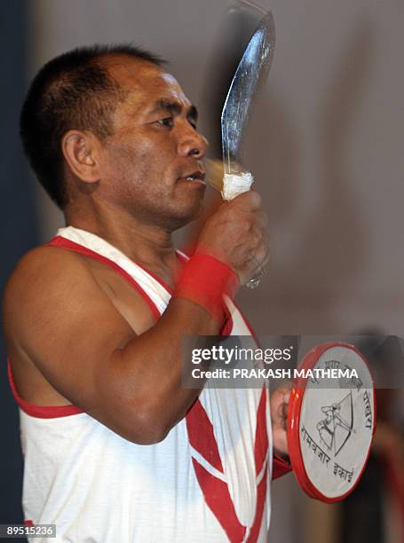 Nepalese men perform the traditional Khukuri dance during a welcoming ceremony for British actress and Gurkha campaigner Joanna Lumley in Pokhara,...