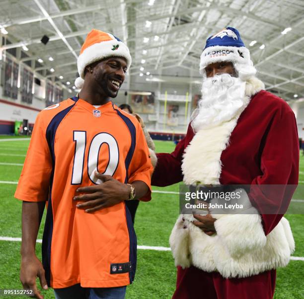 Denver Broncos wide receiver Emmanuel Sanders meets Santa Claus during the Denver Broncos holiday party for 150 kids from all 15 branches of Boys &...