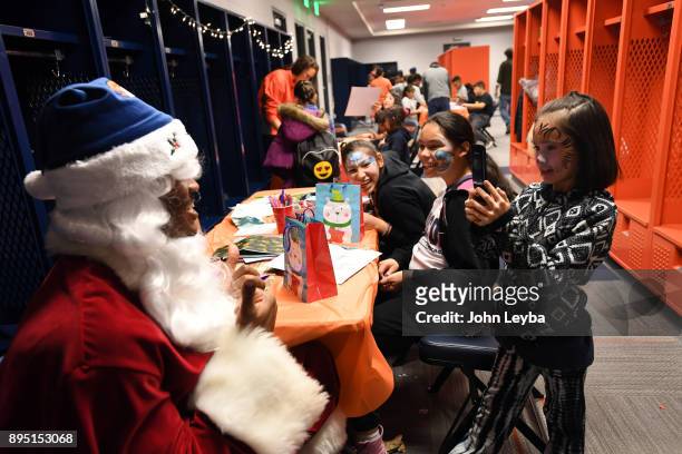 Alexis Rios, Nevaeh Rios and Ezalea meet with Santa Claus during the Denver Broncos holiday party for 150 kids from all 15 branches of Boys & Girls...