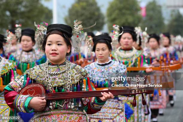 Dong people in traditional costumes parade during the Sama Festival on December 18, 2017 in Rongjiang, Guizhou Province of China. Sama is the goddess...