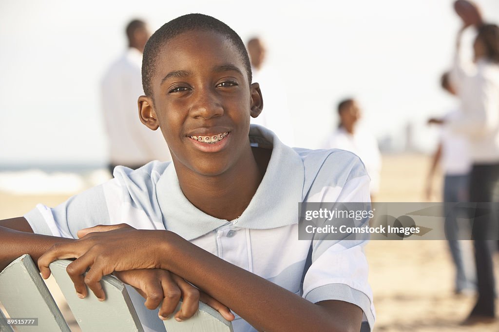 Boy at the beach with people in the background