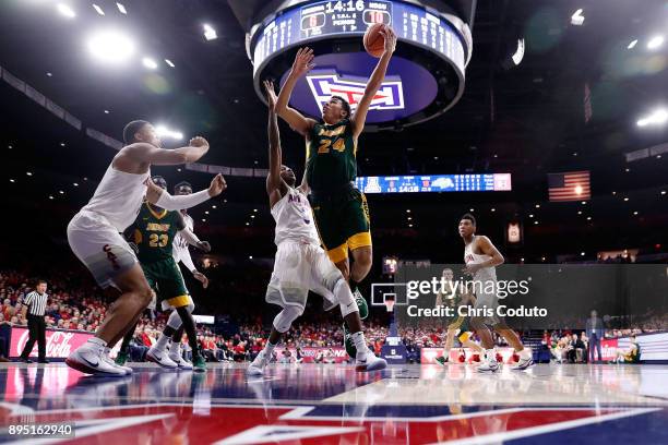 Tyson Ward of the North Dakota State Bison shoots over Dylan Smith and Ira Lee of the Arizona Wildcats during the first half of the college...