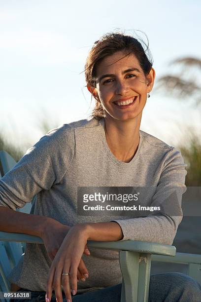 woman in chair on beach - adirondack chair closeup stock pictures, royalty-free photos & images