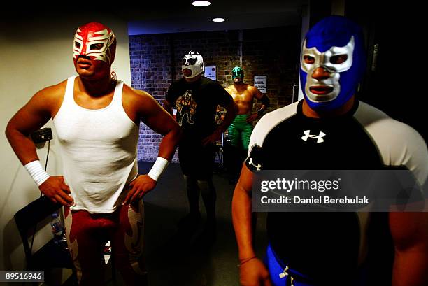 Mexican Lucha Libre Wrestlers Magno, El Hijo de Cien Caras, Black Fish and Blue Demon Jr. Prepare backstage at the Roundhouse in Camden on July 5,...