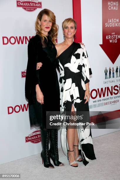 Laura Dern and Kristen Wiig attend the premiere of Paramount Pictures' "Downsizing" at Regency Village Theatre on December 18, 2017 in Westwood,...