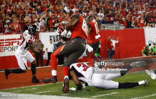 Tight end O.J. Howard of the Tampa Bay Buccaneers is hit by cornerback Brian Poole of the Atlanta Falcons as he runs in for a touchdown during the...