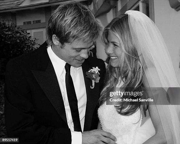 Newlyweds Brad Pitt and Jennifer Aniston pose for pictures Saturday, July 29 in Malibu, California.