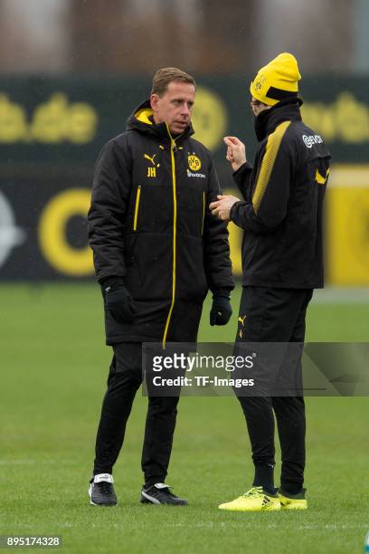 Assistant coach Joerg Heinrich of Dortmund speaks with Neven Subotic of Dortmund during a training session at BVB trainings center on December 13,...
