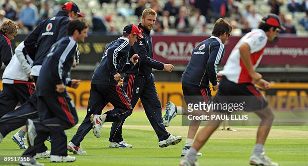 England cricketer Andrew Flintoff warms up with his team mates as rain delays play on the first day of the third Ashes cricket test between England...