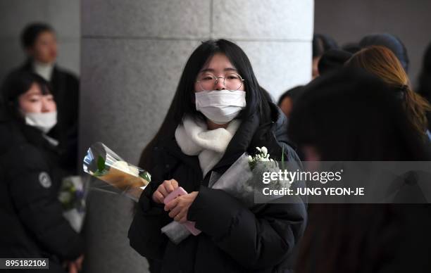 Tearful fans gather to visit the mourning altar for Kim Jong-Hyun, a 27-year-old lead singer of the massively popular K-pop boyband SHINee, at a...