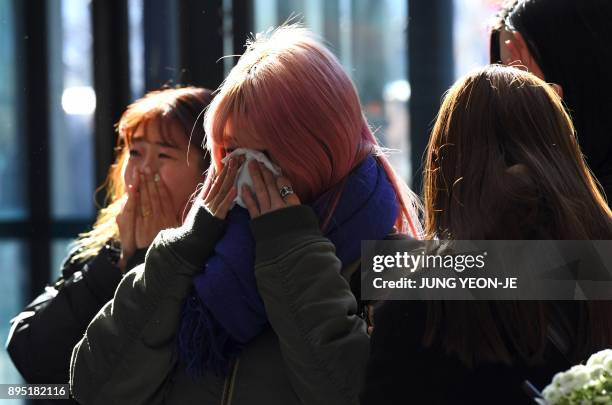 Tearful fans gather to visit the mourning altar for Kim Jong-Hyun, a 27-year-old lead singer of the massively popular K-pop boyband SHINee, at a...