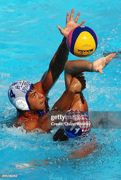 Vanja Udovicic of Serbia and Igor Hinic of Croatia battle for the ball during the 13th FINA World Championships at the Stadio della Pallanuoto on...