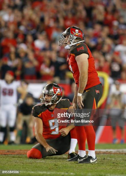 Kicker Patrick Murray of the Tampa Bay Buccaneers and punter Bryan Anger react as they watch Murray's 54-yard field goal attempt go wide right as...