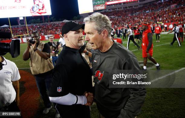 Head coach Dan Quinn of the Atlanta Falcons and head coach Dirk Koetter of the Tampa Bay Buccaneers meet up on the field following the Falcons' 24-21...