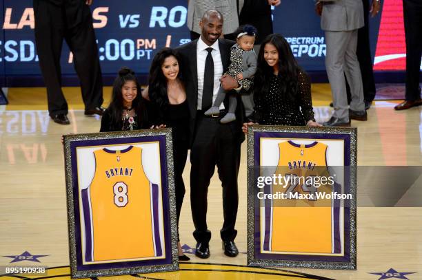 Kobe Bryant poses with his family at halftime after both his and Los Angeles Lakers jerseys are retired at Staples Center on December 18, 2017 in Los...