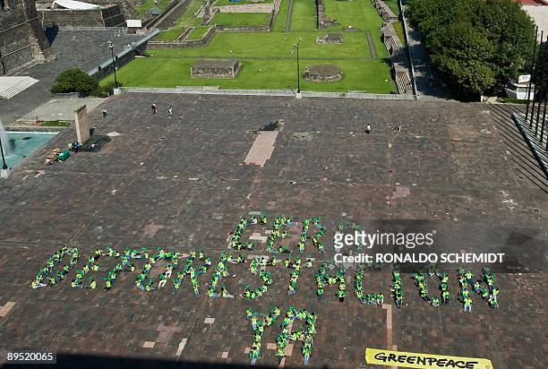 Greenpace activists fall in to form the slogan "Zero deforestation now" at the Plaza de las Tres Culturas in Mexico city on July 30, 2009. AFP...