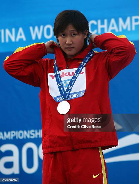 Zige Liu of China receives the silver medal during the medal ceremony for the Women's 200m Butterfly Final during the 13th FINA World Championships...