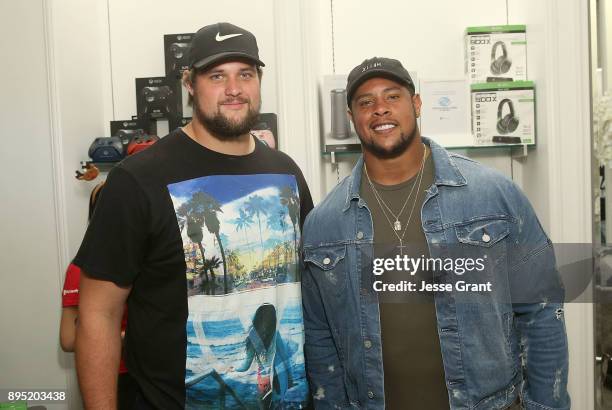 Offensive tackle Rob Havenstein and NFL guard Roger Saffold attend the LA Rams Wives and Girlfriends Holiday Gifting Event at Westfield Topanga Mall...