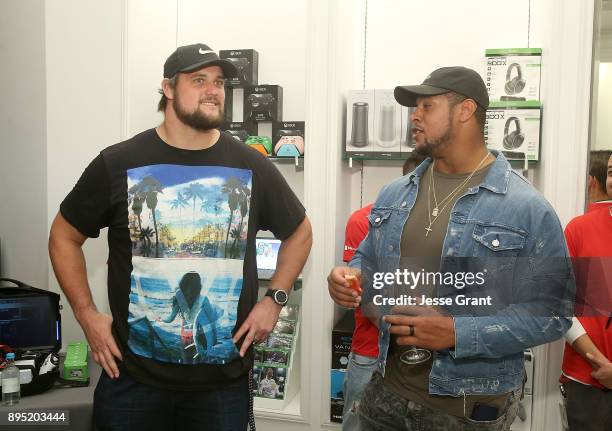 Offensive tackle Rob Havenstein and NFL guard Roger Saffold attend the LA Rams Wives and Girlfriends Holiday Gifting Event at Westfield Topanga Mall...