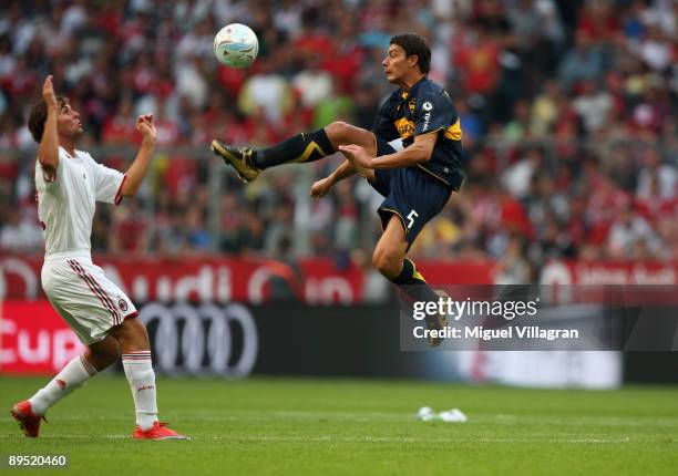 Battaglia of Boca Juniors and Gianmarco Zigoni of AC Milan challenge for the ball during the Audi Cup tournament match between Boca Juniors v AC...