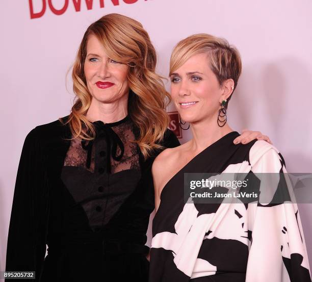 Actresses Laura Dern and Kristen Wiig attend the premiere of "Downsizing" at Regency Village Theatre on December 18, 2017 in Westwood, California.