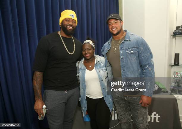 Defensive tackle Michael Brockers, Faith Brockers and NFL guard Roger Saffold attend the LA Rams Wives and Girlfriends Holiday Gifting Event at...